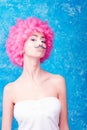 Blue eye comic girl / woman / teenager with pink curly wig is we Royalty Free Stock Photo