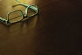 Blue eye glasses on wooden brown table. Royalty Free Stock Photo