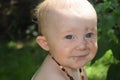 Blue eyed baby with dirt on face