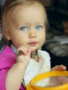 Blue Eyed Baby Girl eating. Royalty Free Stock Photo