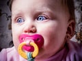 Blue-eyed Baby sucking pacifier