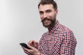 Blue-eyed bearded man taking his black phone for calling his wife