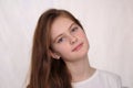 blue eyed brown haired shy girl in t-shirt. Studio model shot Royalty Free Stock Photo