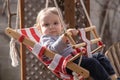 Blue eyed canadian toddler playing in backyard swing Royalty Free Stock Photo