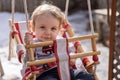 Blue eyed canadian toddler playing in backyard swing Royalty Free Stock Photo