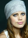 Blue-eyed girl in a grey cap with pastes