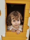 Blue-eyed girl playing in the dollhouse Royalty Free Stock Photo