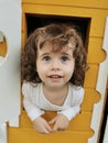 Blue-eyed girl playing in the dollhouse Royalty Free Stock Photo