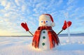 Blue eyed snowman. Sunrise enlightens the sky and clouds by warm colors. Reflecting on the snow. Mountains landscape. Joyful cold