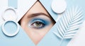 Blue eyeshadow eye makeup with white decorative elements and palm leaf lashes Royalty Free Stock Photo