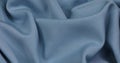 Blue fabric background. Blue cloth waves background texture.