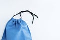 Blue fabric bag with black lace close-up on white background Royalty Free Stock Photo