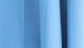 Blue fabric folds creating abstract shapes and shadows
