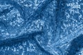 Blue fabric with folds and holographic effect. Abstract geometric background or texture
