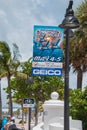 Blue fabric sign on a lamp post advertising the Fort Lauderdale Air Show that took place on May 4th and 5th. There are palm trees