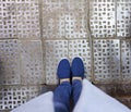 Blue fabric slip-ons. Photo of legs in jeans and shoes from top to bottom