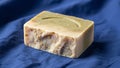 On a blue fabric surface. The soap features a smooth upper surface Royalty Free Stock Photo