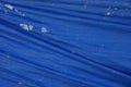 Blue fabric texture from crumpled worn tarp covering Royalty Free Stock Photo