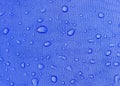 Blue fabric texture with water drops. Waterproof fabric Royalty Free Stock Photo