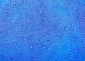 Blue fabric texture with water drops. Waterproof fabric Royalty Free Stock Photo