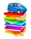 Blue family car on a stack of colorful books Royalty Free Stock Photo