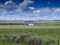 Blue farmhouse in the valley in Utah, the USA under the cloudy sky