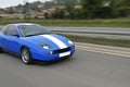 Blue fast sport car on hiway Royalty Free Stock Photo