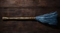 a blue feathered broom on a wooden surface