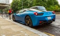 Blue Ferrari 458 parked in street in London