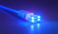 Blue fiber optic cable with glowing end light, fiber optic, cable, blue, technology, data, communication, connection Royalty Free Stock Photo