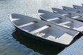 Blue fiberglass boats are moored to the pier at the riverbank Royalty Free Stock Photo