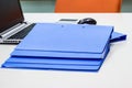 Blue file folder with documents and Notebook background on the white table Royalty Free Stock Photo