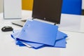 Blue file folder with documents and Notebook on the white table Royalty Free Stock Photo