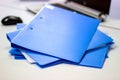 Blue file folder with documents and Notebook on the white table Royalty Free Stock Photo