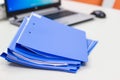 Blue file folder with documents and Notebook on the white table Royalty Free Stock Photo