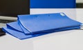 Blue file folder with documents and Notebook on the white table Royalty Free Stock Photo