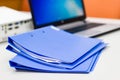 Blue file folder with documents and Notebook on the white table Royalty Free Stock Photo