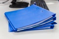 Blue file folder with documents on table in work office Royalty Free Stock Photo
