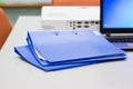 Blue file folder with documents on the white table Royalty Free Stock Photo