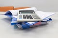 Blue file folder with paper, calculation on the table in work office room Royalty Free Stock Photo