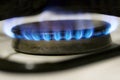 Blue fire in gas burner. Natural gas burning on kitchen gas stove. Global energy crisis concept. Panel from steel with Royalty Free Stock Photo