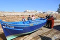 Blue fishing boat being launched