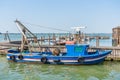 Blue fishing boat docked or moored in Burano, Venice Royalty Free Stock Photo