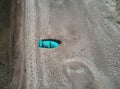 Blue fishing boat seen from above at the sea