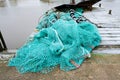 Blue fishing net on a pontoon with its ropes and floats covered with morning frost Royalty Free Stock Photo