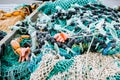 Blue fishing net on a pontoon with its ropes and floats covered with morning frost Royalty Free Stock Photo