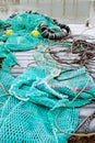 Blue fishing net on a pontoon with its ropes and floats covered with morning frost Royalty Free Stock Photo