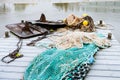 Blue fishing net on a pontoon with its ropes and floats covered with morning frost Royalty Free Stock Photo