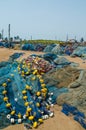 Blue fishing nets with yellow swimmers spread on the ground at harbor of Elmina, Ghana, West Africa Royalty Free Stock Photo