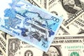 A blue tenge note from Kazakhstan with American one dollar bills